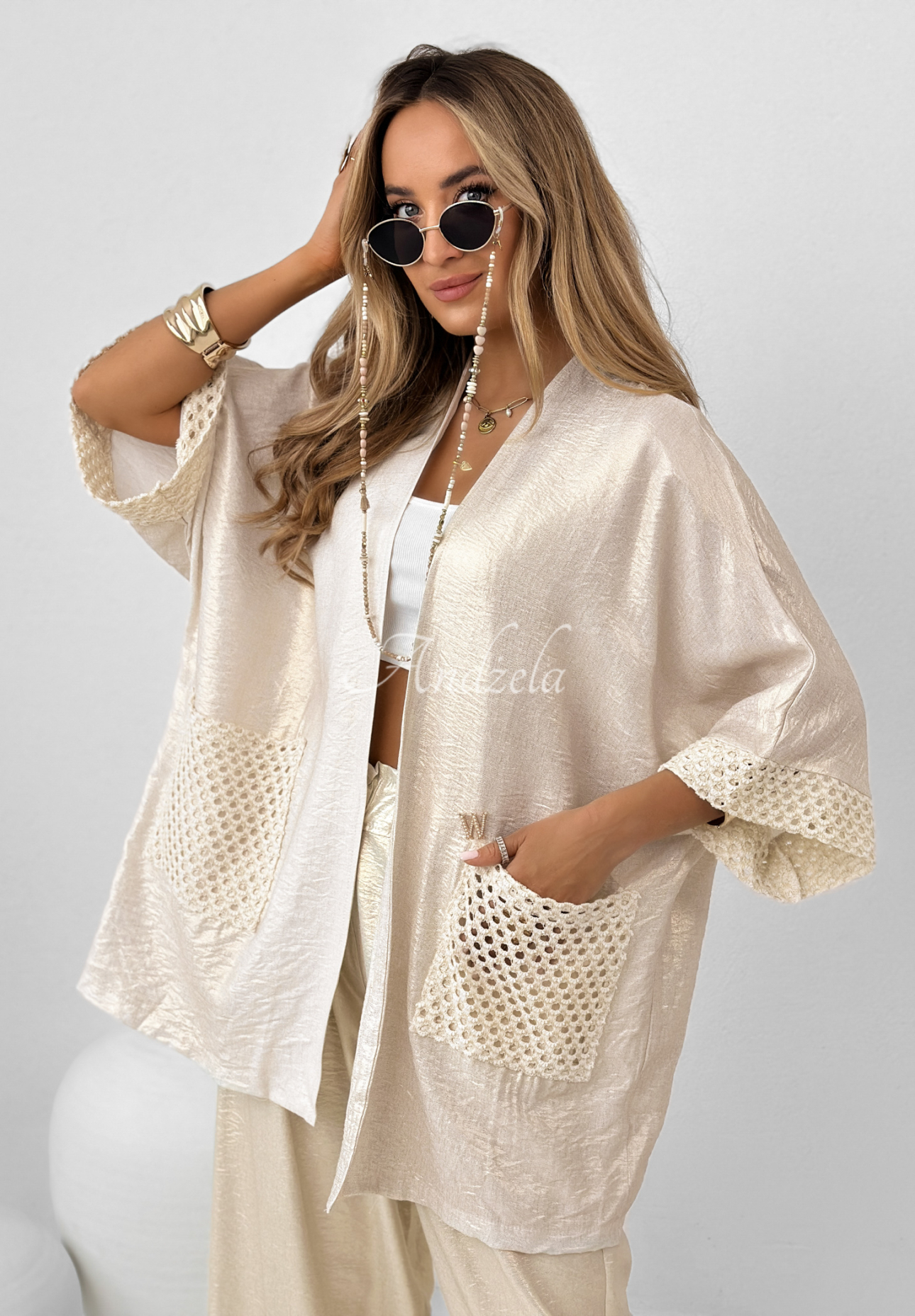 Oceanic Crest gold cardigan with openwork pockets