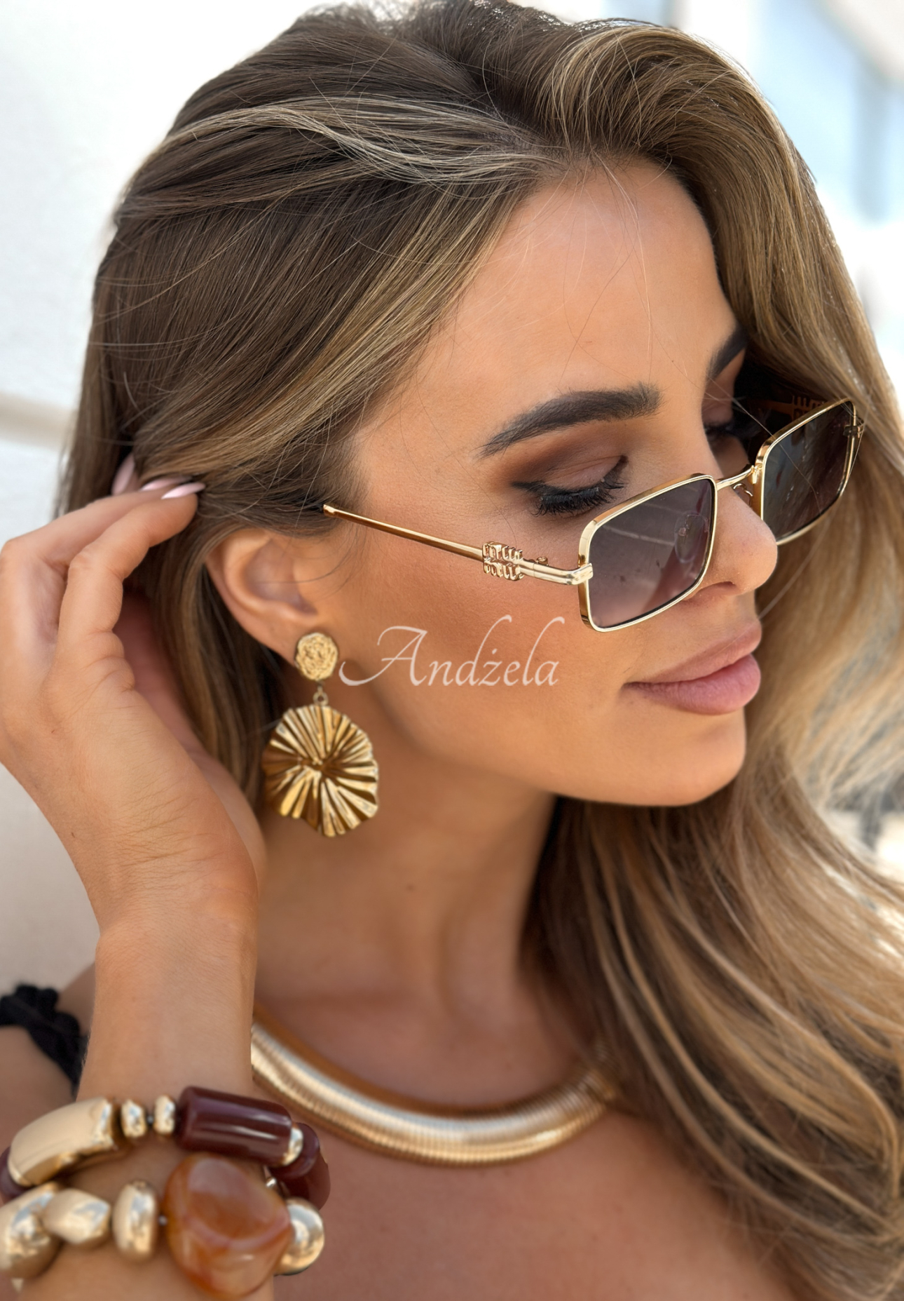 Shade Wave gold and black sunglasses.