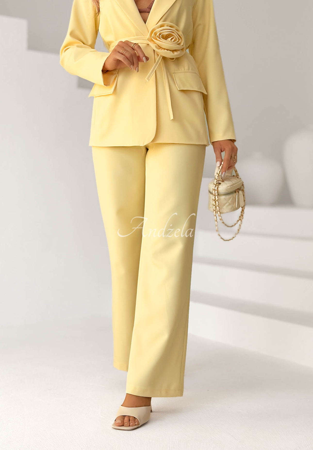 Elegant women's suit with a yellow Tessa flower