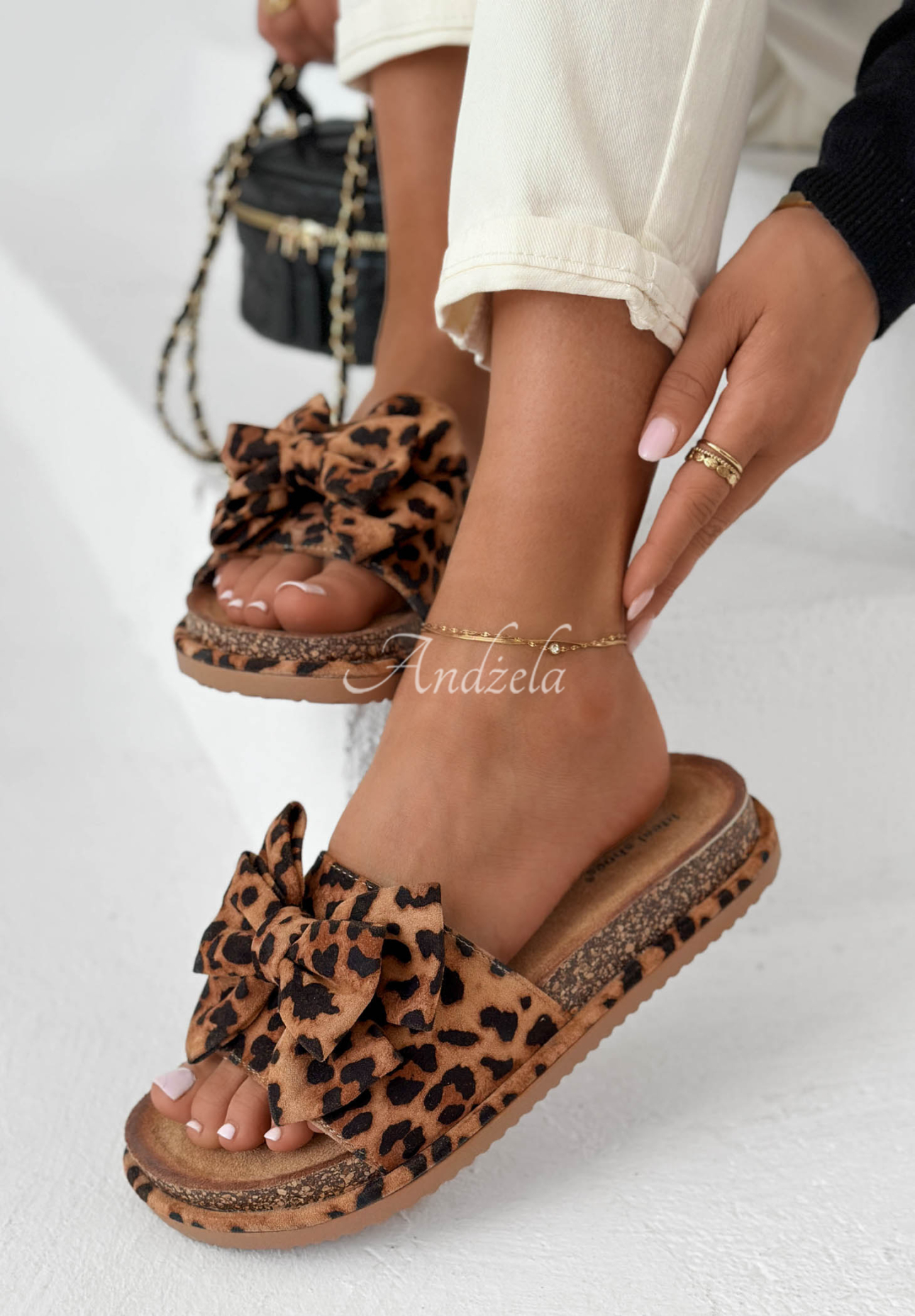 Ismeralda camel-colored flip-flops with a leopard-print bow