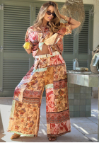 Materiałowe spodnie wide leg we wzory Riviera Sunset beżowo-pomarańczowe